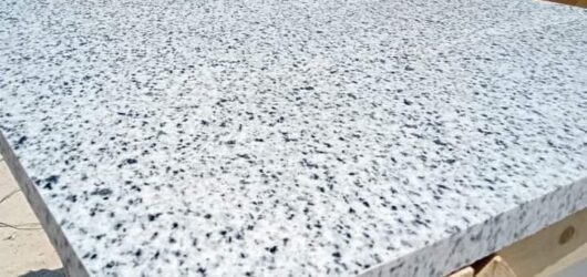 “Bianco Halaib granite with a white-gray background, natural black and gray speckles, and a polished finish.”
